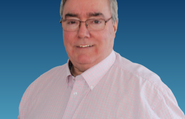 A portrait of Pontiac Conservative candidate Michel Gauthier, wearing a white collared shirt and glasses in front of a blue background, with a Conservative Party watermark near the bottom.