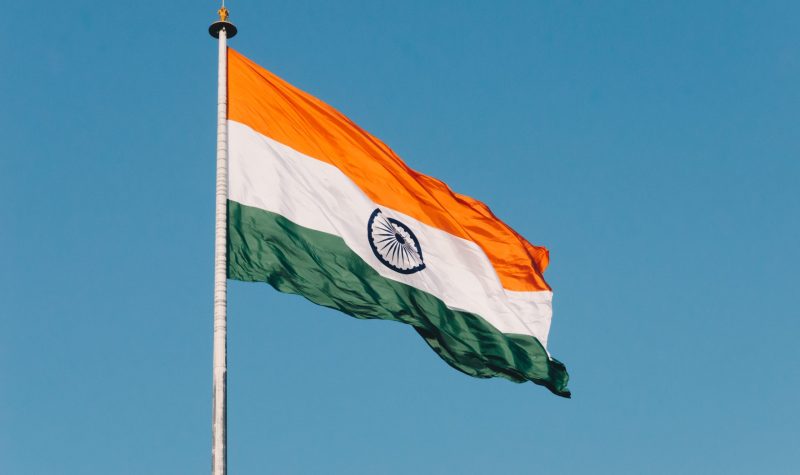 The Indian flag flies against a clear blue sky