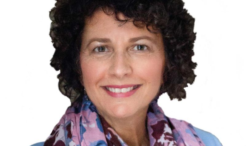 A headshot of agriculture Minister Pam Alexis smiling wearing a blue jacket and a multicolored scarf.