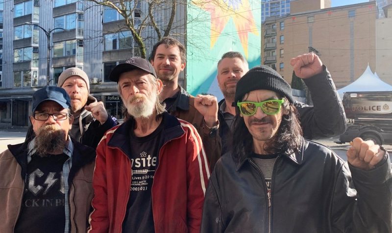 A group of Downtown Eastside harm reduction peer support workers standing together outside.