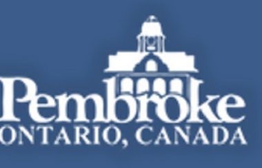 The logo of the town of Pembroke, white on a blue background.