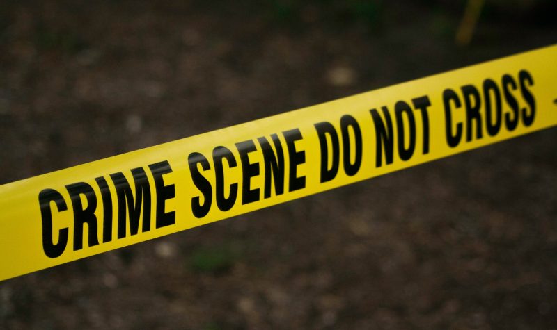 Stock photo of yellow crime scene tape with the words 'crime scene do not cross'