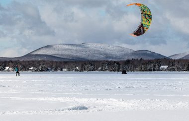 Kite skier on snowy brome lake
