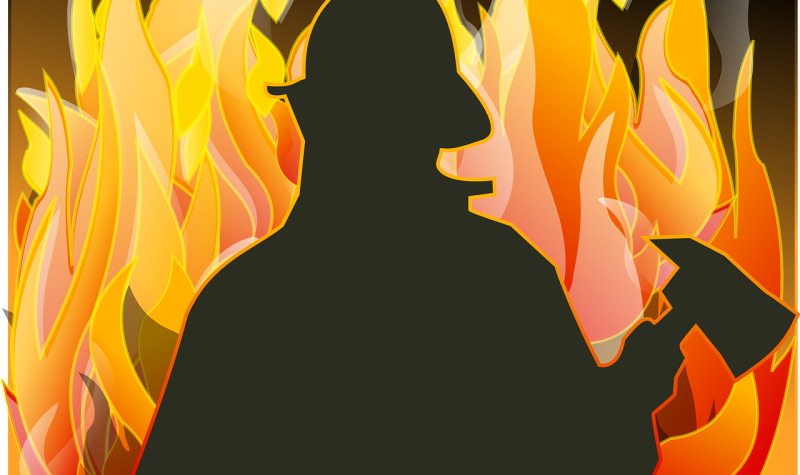 A drawing of a firefighter silhouetted in front of flames.