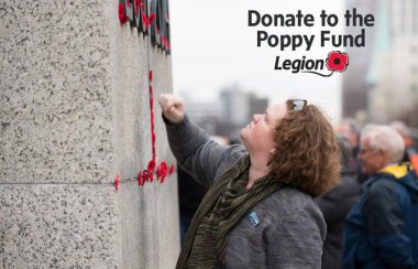 A woman looks up at a stone wall in a promotional poster for the Royal Canadian Legion Poppy Fund.