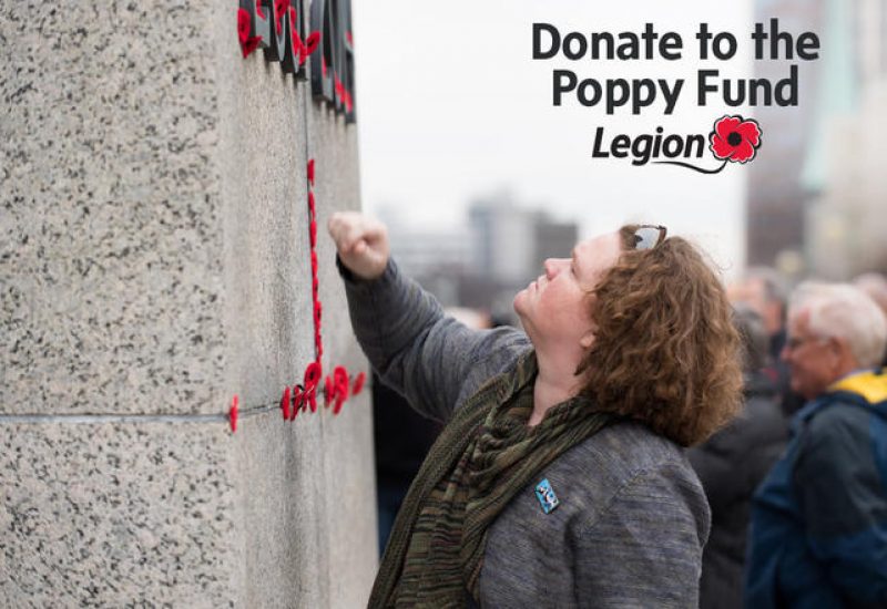 A woman looks up at a stone wall in a promotional poster for the Royal Canadian Legion Poppy Fund.