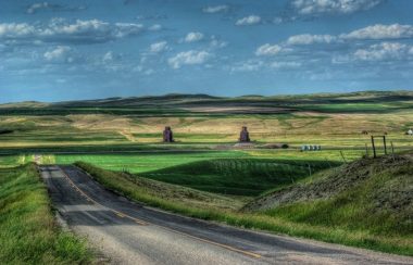 A photo of a sunny road in the Canadian prairies.