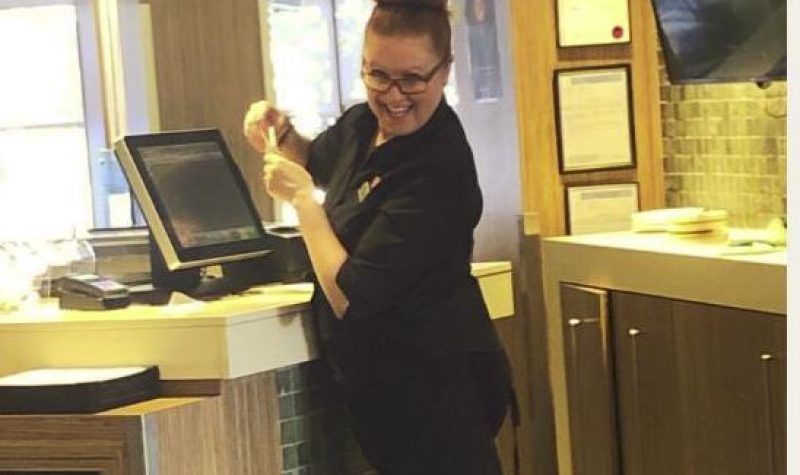Marcia Little stands at the cashier at a hotel in Nanaimo