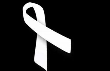 A white ribbon on a black background.