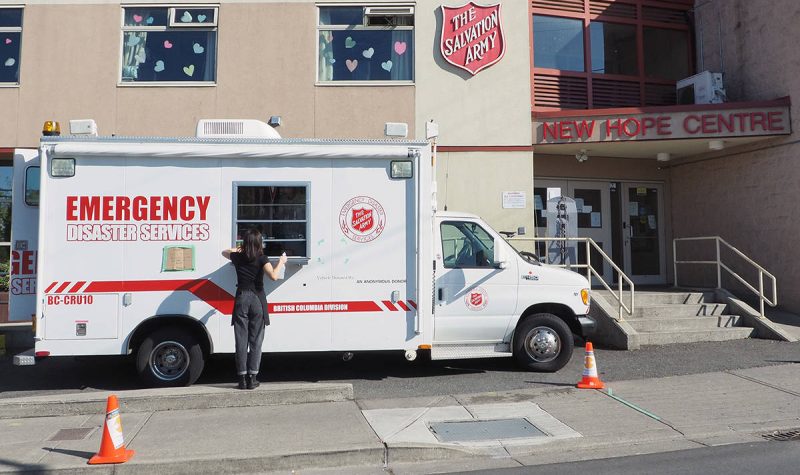 A picture of a white truck with a take out window outside of the Salvation Army in Nanaimo.