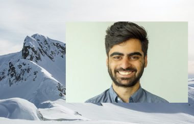 staff writer salmaan farooqui portrait on top of snow covered bc mountains