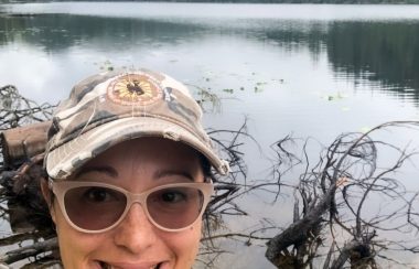 INdigenous woman in front of a lake