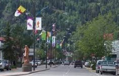 the downtown of Smithers BC is a tree-lined street with potted plants and flags along the entire 5 blocks.