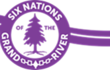 The purple and white Six Nations Elected Council logo. It featured a purple pine tree graphic at the centre.