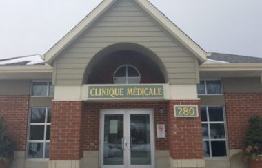The outside of the Knowlton Medical Clinic front doors on an overcast day