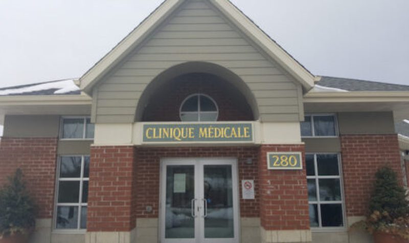 The outside of the Knowlton Medical Clinic front doors on an overcast day