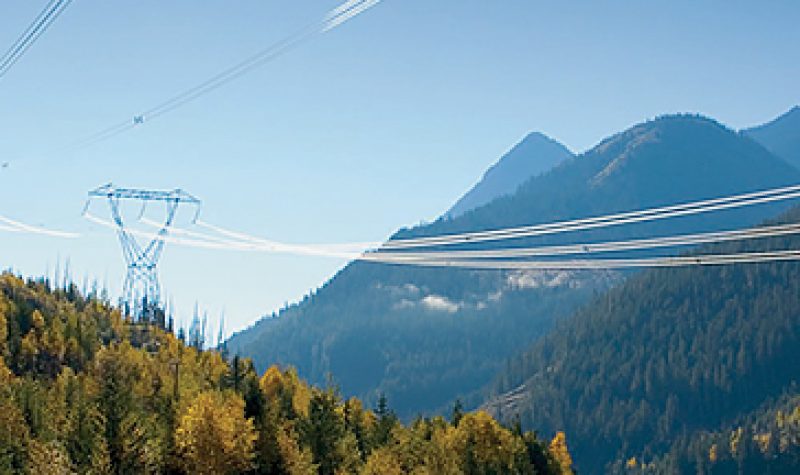 a photo of power lines running through a mountain range