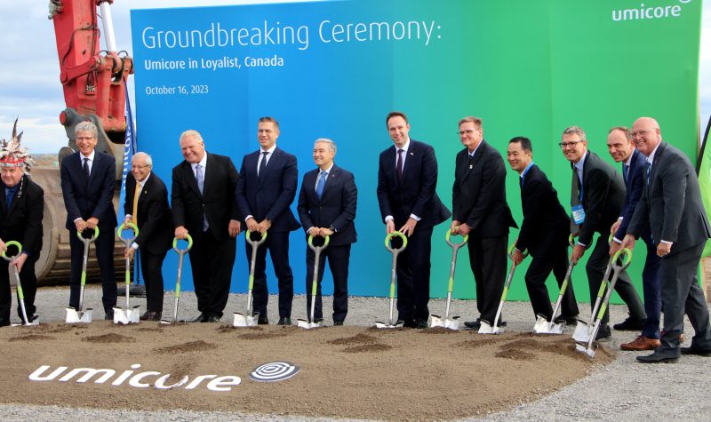 Members of Umicore along with Federal, Provincial, and Municipal politicians, as well as a local Indigenous leader gather around a ceremonial ground-breaking all holding shovels