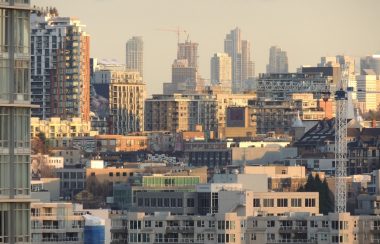 A city skyline with houses under construction