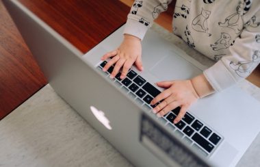 Enfant appuyant sur les touches d'un clavier de MacBook pro